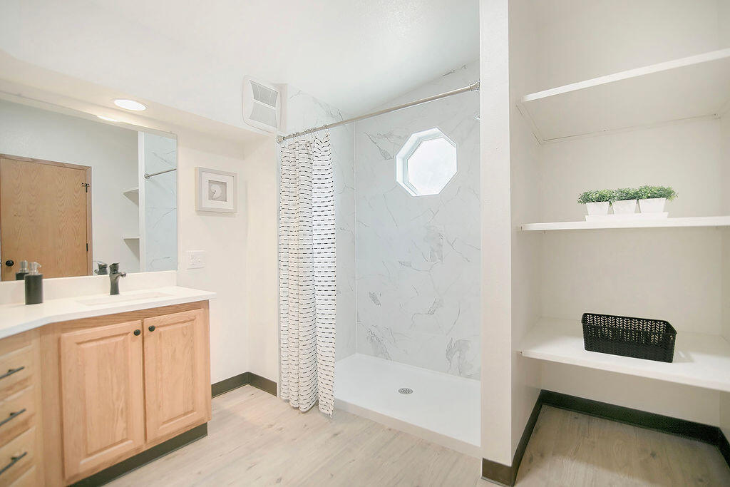 17231 Downey Road Bend, OR 97707 - Photo 20 of 40 a bathroom with a double vanity sink a toilet and shower