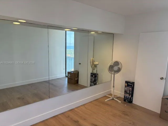 a view of an empty room with glass door