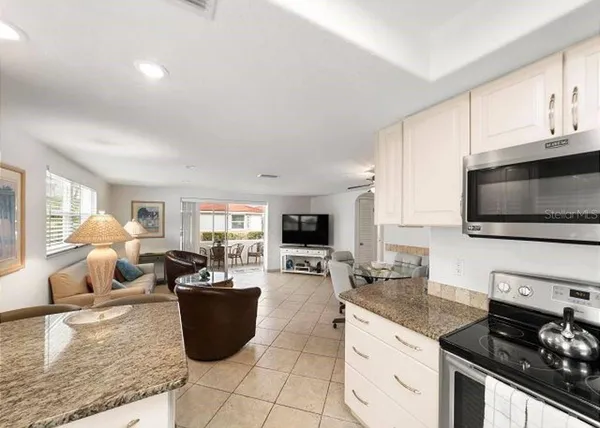 a kitchen with a stove a sink a microwave and cabinets