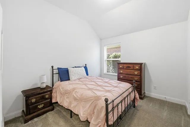 a bedroom with a bed and a dressers