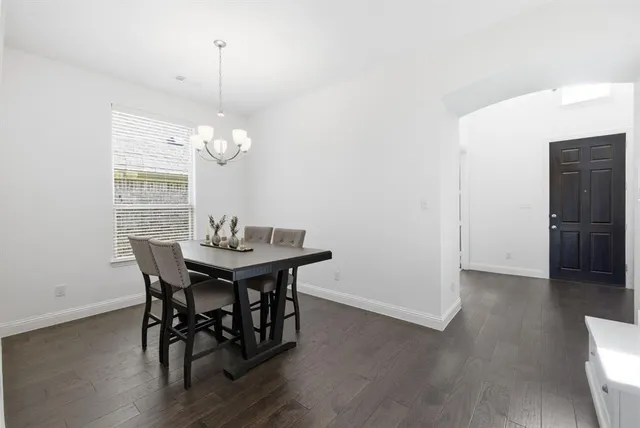 a dining room with furniture wooden floor and a chandelier