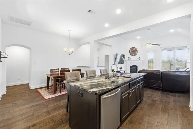 a kitchen with a stove a counter space and a couch