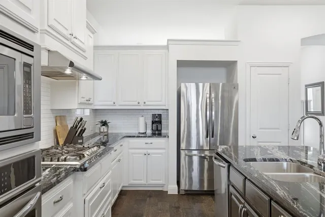 a kitchen with a sink stove and refrigerator