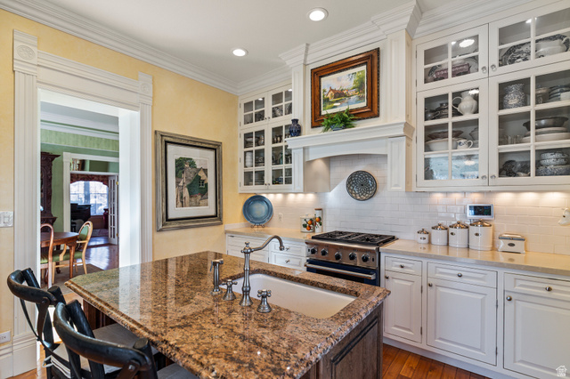 390 North 100 West Monroe, UT 84754 - Photo 6 of 167 Kitchen with white cabinetry, high end stainless steel range oven, dark stone counters, tasteful backsplash, and ornamental molding