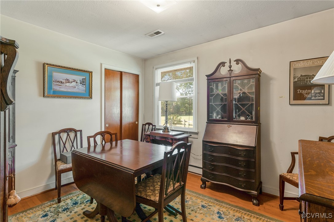 10522 Summer Hill Road Mechanicsville, VA 23116 - Photo 6 of 48 a dining room with furniture a rug and wooden floor