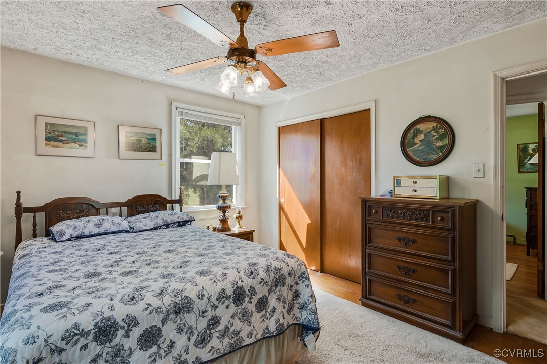 10522 Summer Hill Road Mechanicsville, VA 23116 - Photo 9 of 48 a bedroom with a bed and a chandelier