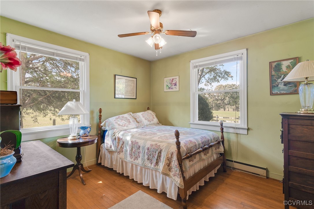 10522 Summer Hill Road Mechanicsville, VA 23116 - Photo 10 of 48 a bedroom with a bed and a table in it with window