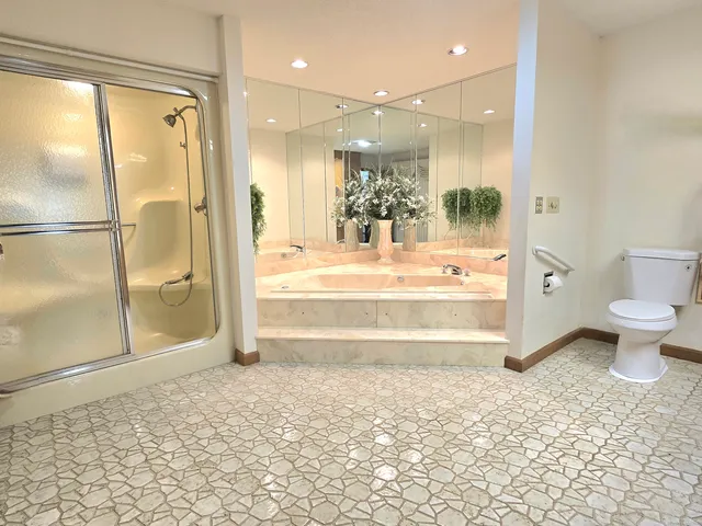 a view of a bathroom with a glass door shower