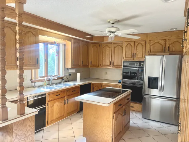 a kitchen with a sink appliances and cabinets