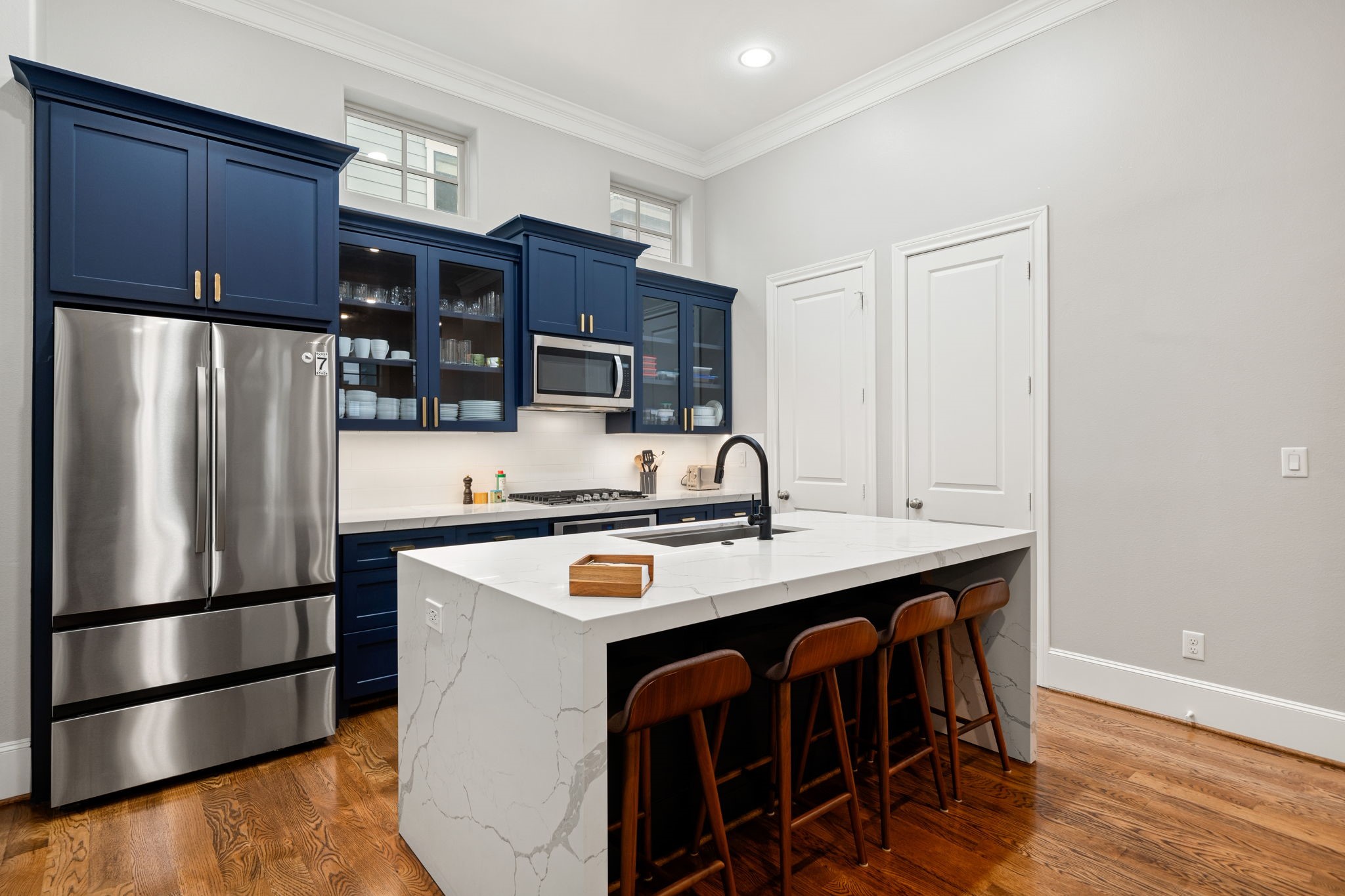 3277 Maxroy Street Houston, TX 77008 - Photo 1 of 27 a kitchen with stainless steel appliances a sink a stove a refrigerator and cabinets