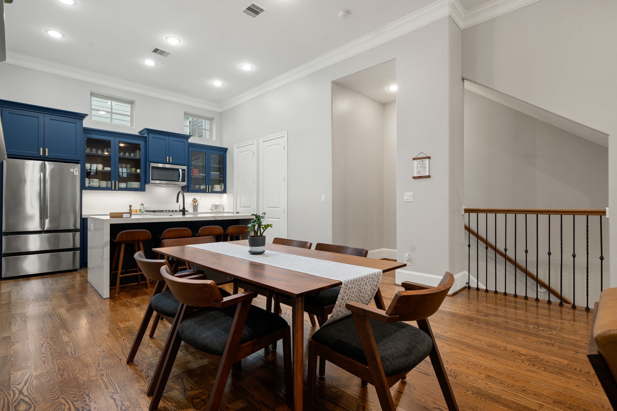 3277 Maxroy Street Houston, TX 77008 - Photo 12 of 27 a kitchen with stainless steel appliances kitchen island granite countertop a dining table chairs and a refrigerator
