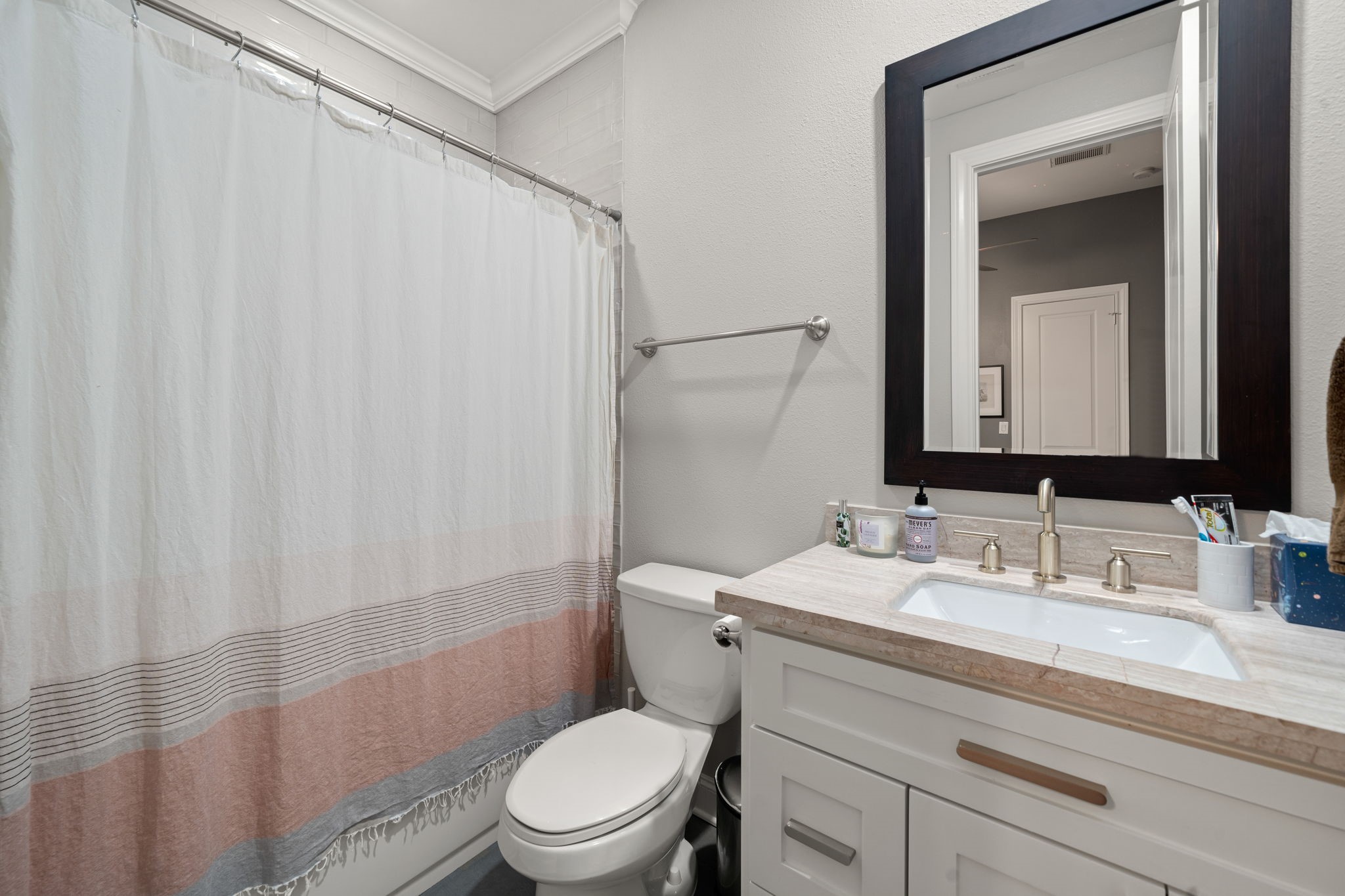 3277 Maxroy Street Houston, TX 77008 - Photo 23 of 27 a bathroom with a sink a toilet and shower curtain