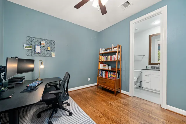 a view of a workspace with furniture and a workspace