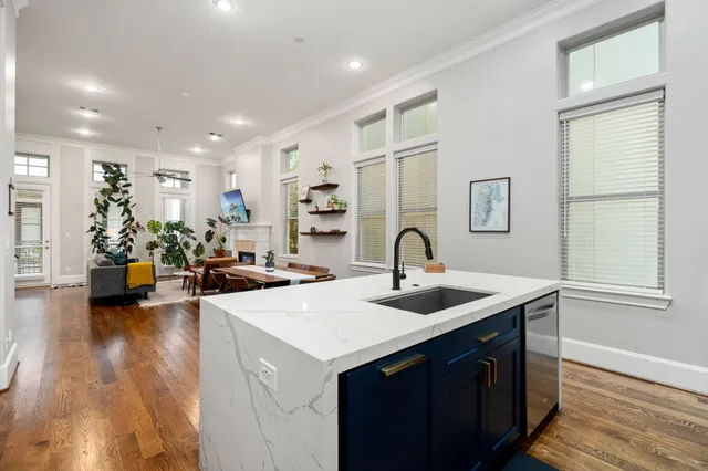 a kitchen with sink and living room