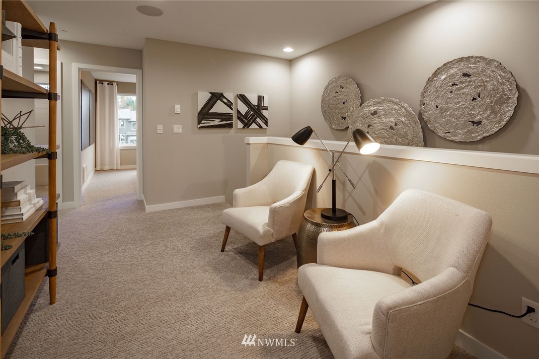 619 238th Street Southeast, Unit B Bothell, WA 98021 - Photo 16 of 20 a living room with furniture a clock and a flat screen tv