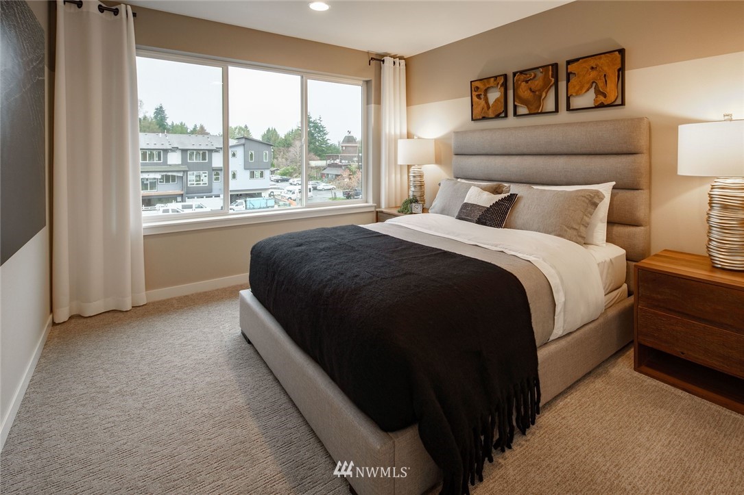 619 238th Street Southeast, Unit B Bothell, WA 98021 - Photo 17 of 20 a bedroom with a bed and a large window