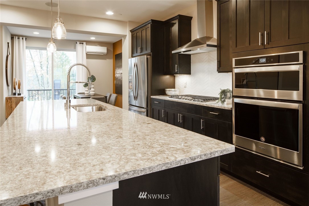 619 238th Street Southeast, Unit B Bothell, WA 98021 - Photo 5 of 20 a kitchen with stainless steel appliances granite countertop a sink stove and refrigerator