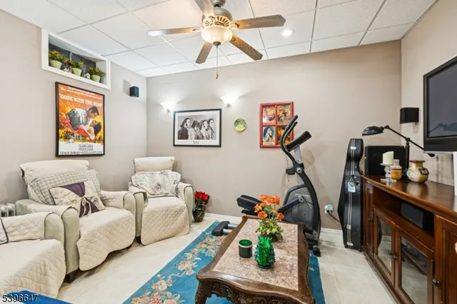 a living room with furniture a window and gym equipment