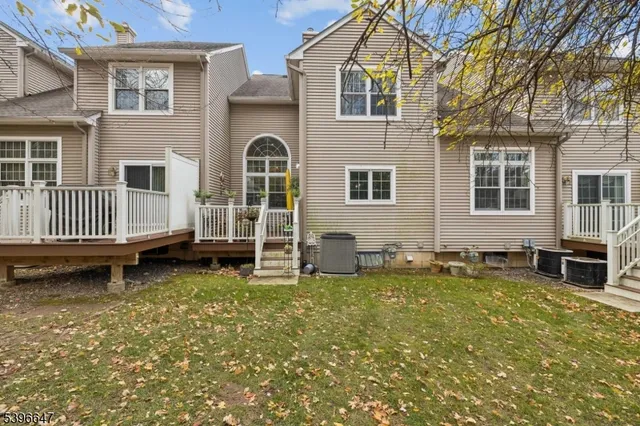 a view of a house with a yard and sitting area