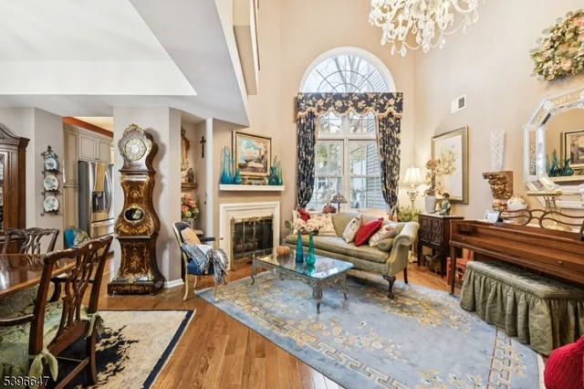 a living room with fireplace furniture and a chandelier