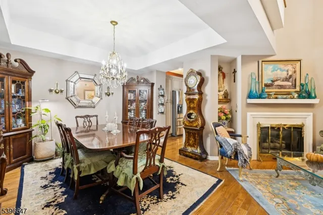 a view of a dining room with furniture and chandelier