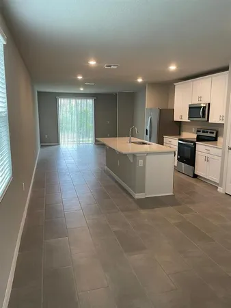 a view of kitchen with granite countertop lots of counter top space