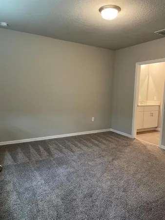 a view of an empty room and a window