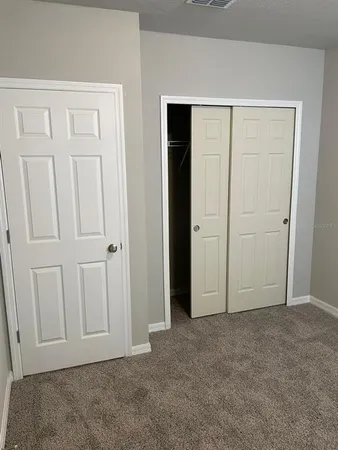 an empty room with closet area