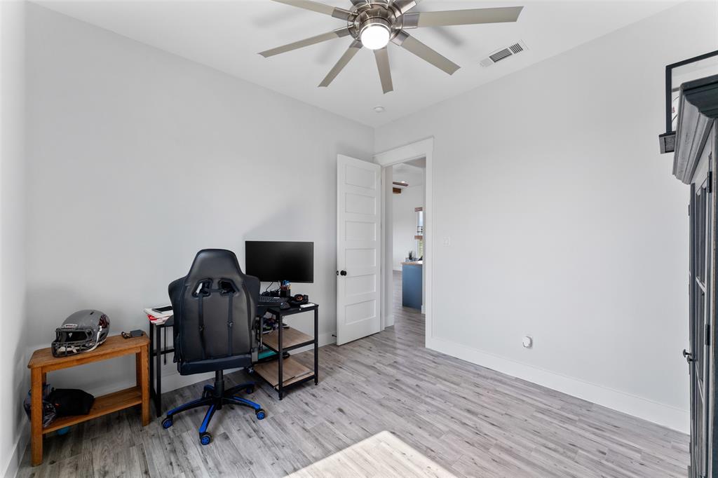 4411 Fm 751 Wills Point Wills Point, TX 75169 - Photo 32 of 40 Interior room featuring light wood-finish flooring, crisp white walls, and a contemporary ceiling fan with integrated lighting