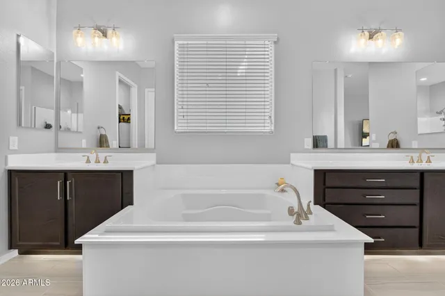 a bathroom with a sink a toilet a mirror and shower curtain