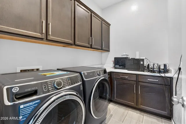 a view of a patio with a table and chairs under an umbrella
