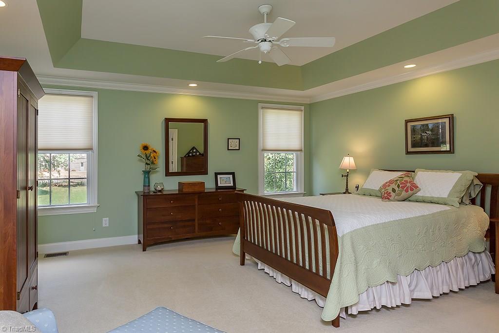 5803 Beckenham Way Oak Ridge, NC 27310 - Photo 12 of 28 Master bedroom! Newer carpeting, tray ceiling, overlooking rear yard and gardens.