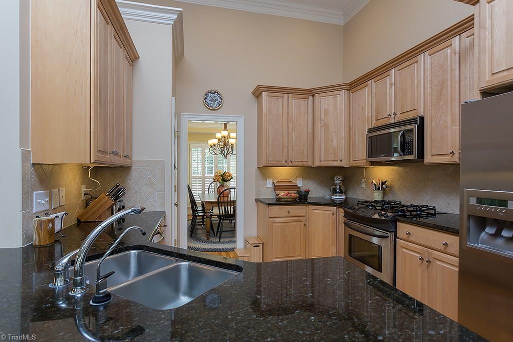 5803 Beckenham Way Oak Ridge, NC 27310 - Photo 5 of 28 Granite countertops, 42 inch wall cabinets, stainless appliances with gas range/oven.