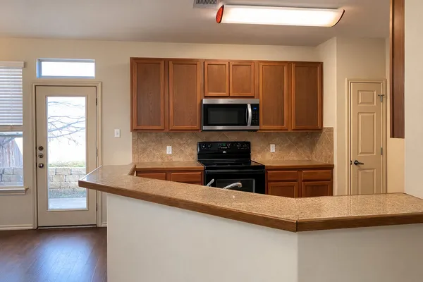 a kitchen with a refrigerator stove and microwave