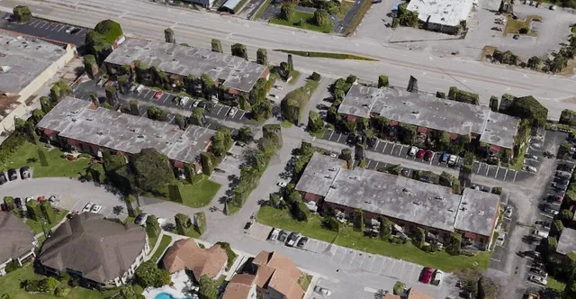 an aerial view of a house with a yard