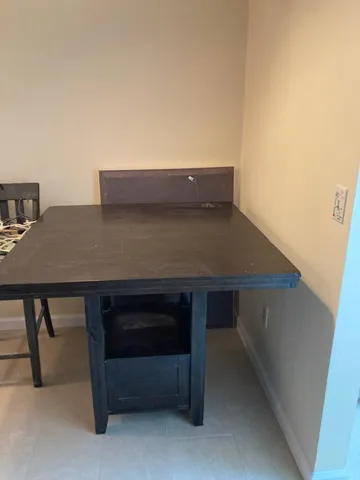 a view of table and chair in the room