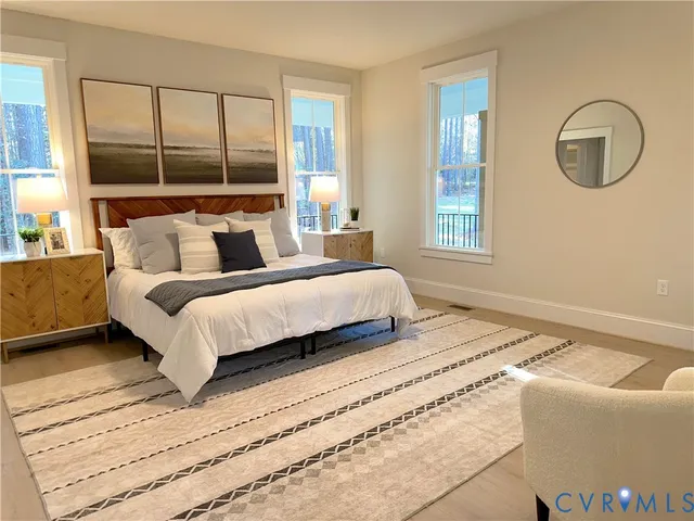 a bedroom with a large bed and a window