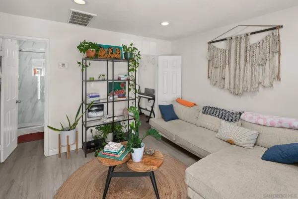 a living room with furniture and wooden floor