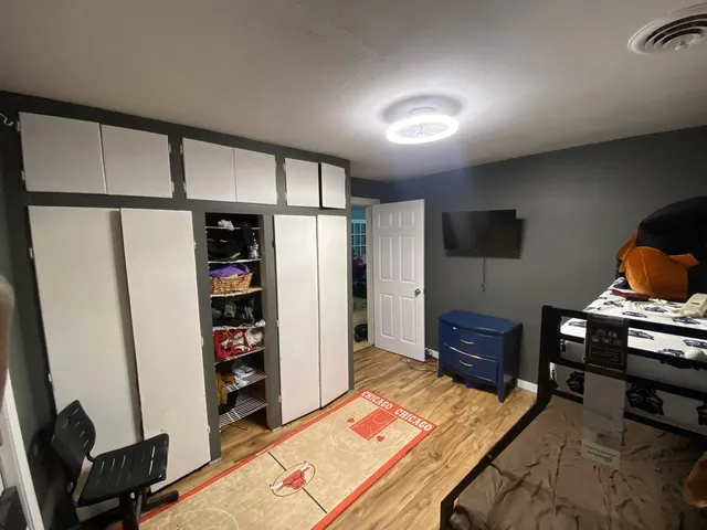 a bedroom with furniture and a book shelf