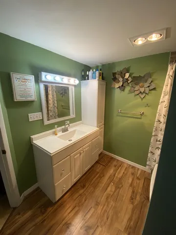 a spacious bathroom with a sink and a mirror