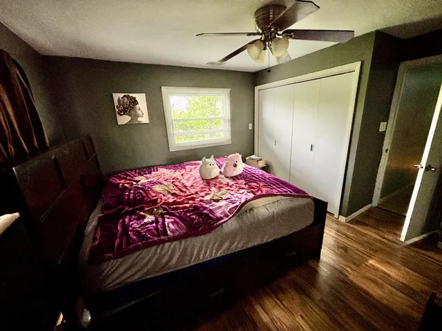 a bedroom with a bed dresser and a window