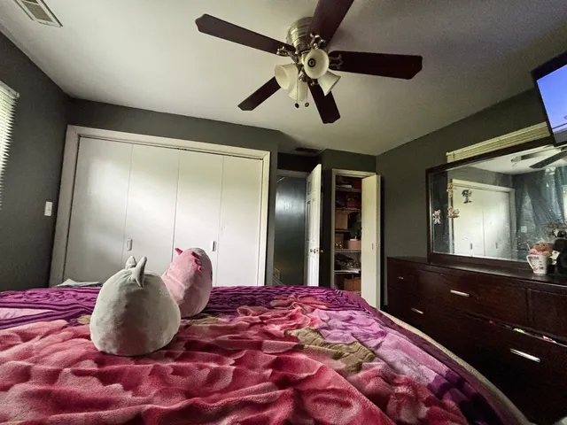 a bedroom with a large bed and a chandelier