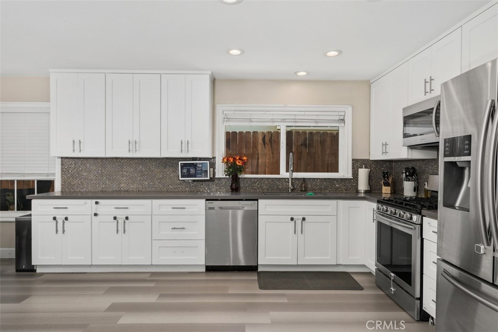 895 West Crestview Street Corona, CA 92882 - Photo 12 of 25 a kitchen with stainless steel appliances granite countertop a stove a sink and a refrigerator