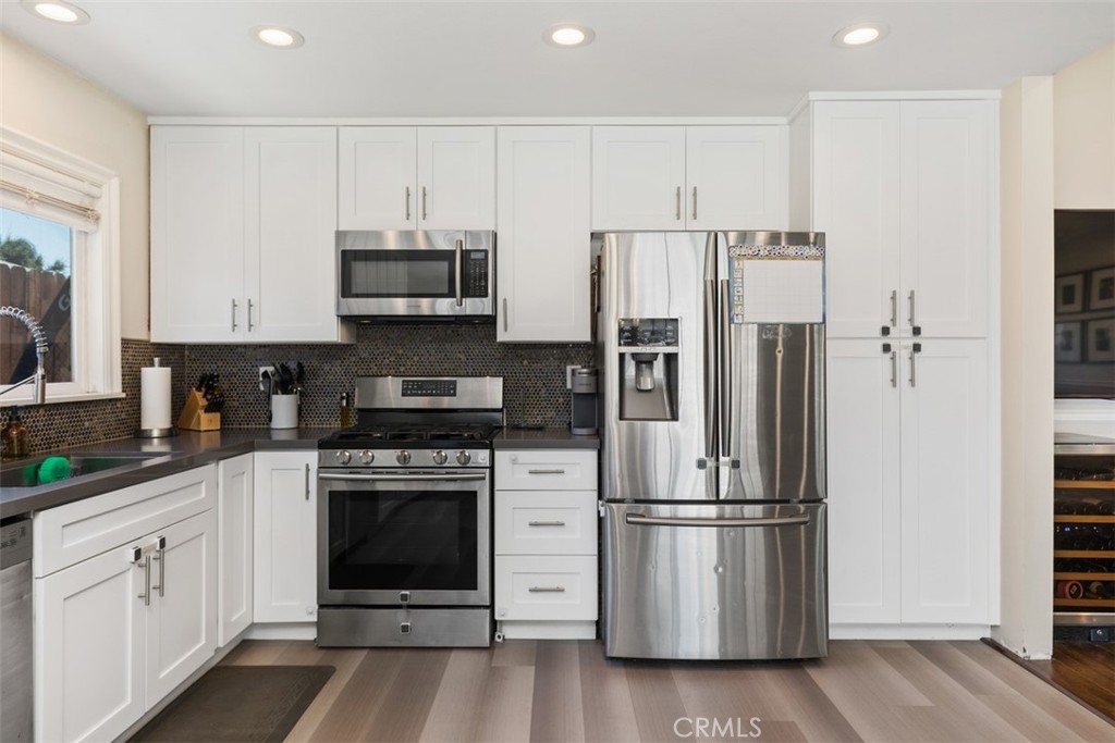 895 West Crestview Street Corona, CA 92882 - Photo 13 of 25 a kitchen with stainless steel appliances white cabinets and a refrigerator