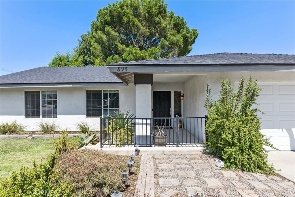 895 West Crestview Street Corona, CA 92882 - Photo 2 of 25 a front view of a house with garden