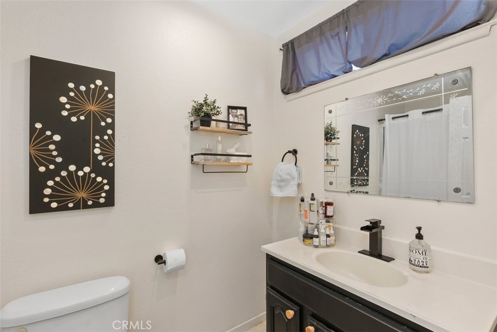 895 West Crestview Street Corona, CA 92882 - Photo 21 of 25 a bathroom with a sink vanity mirror and toilet
