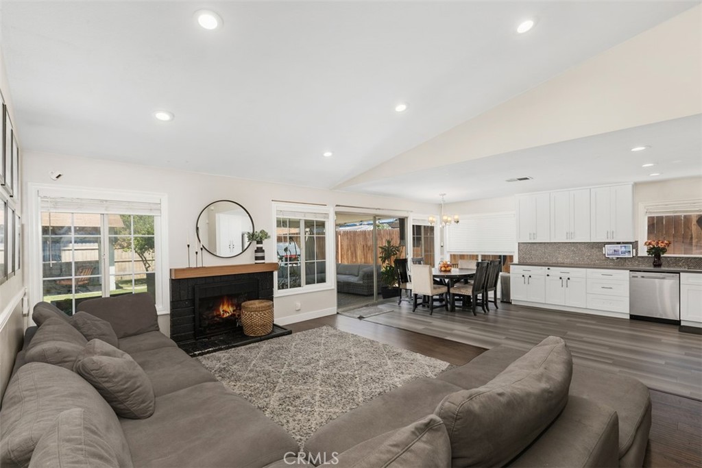 895 West Crestview Street Corona, CA 92882 - Photo 5 of 25 a living room with furniture a fireplace and a large window