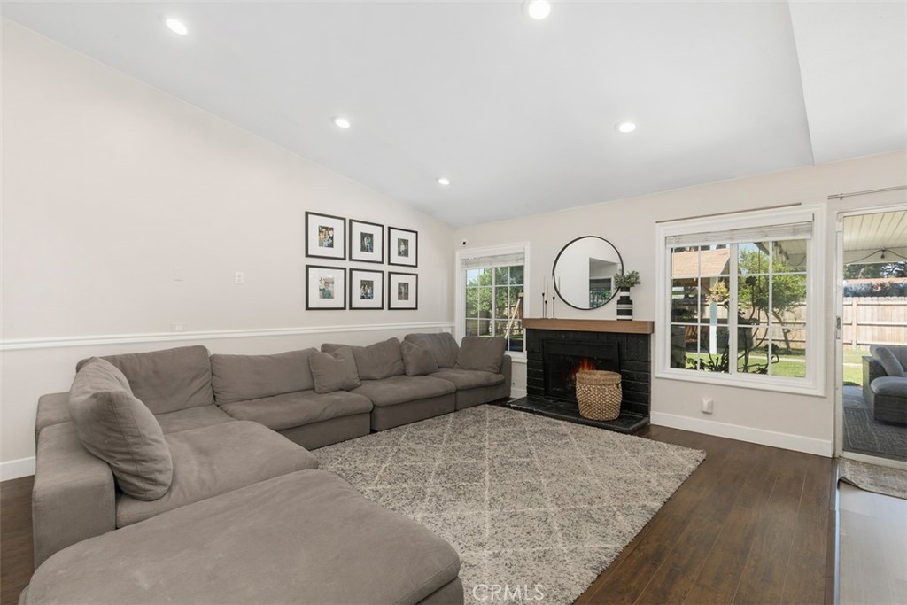 895 West Crestview Street Corona, CA 92882 - Photo 6 of 25 a living room with furniture a fireplace and a floor to ceiling window
