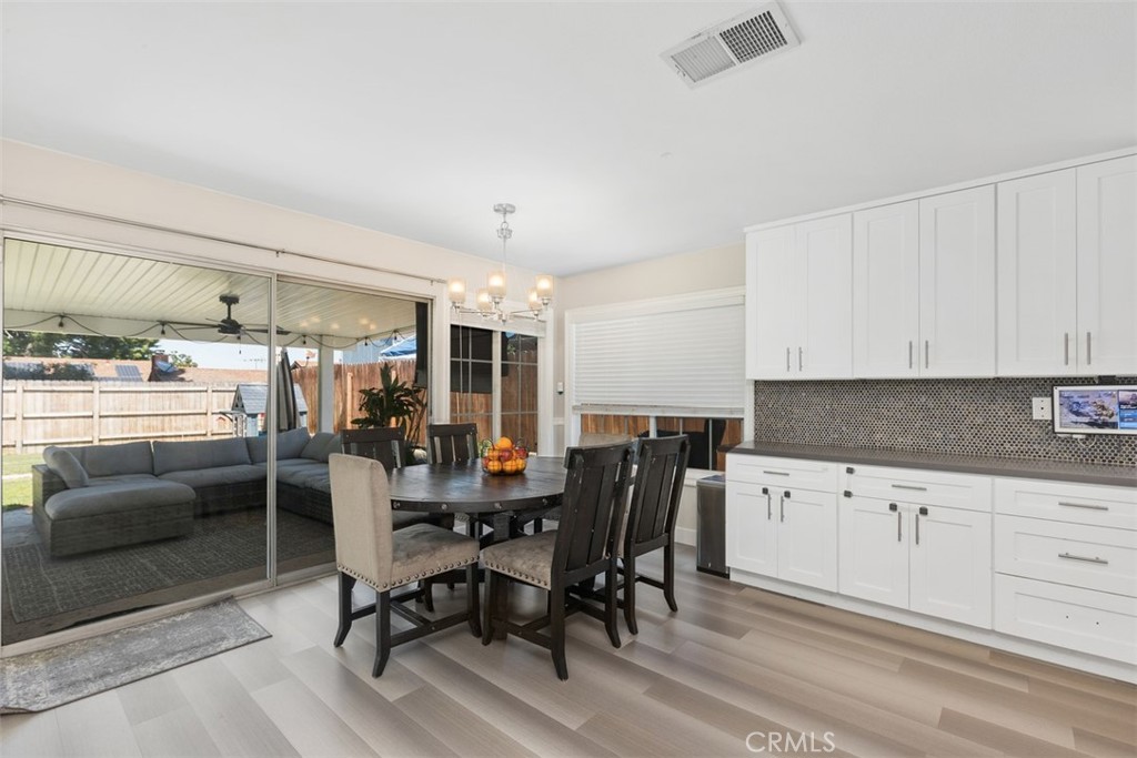 895 West Crestview Street Corona, CA 92882 - Photo 10 of 25 a view of a dining room with furniture and chandelier