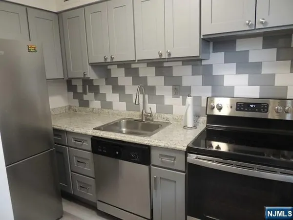a kitchen with a sink and cabinets